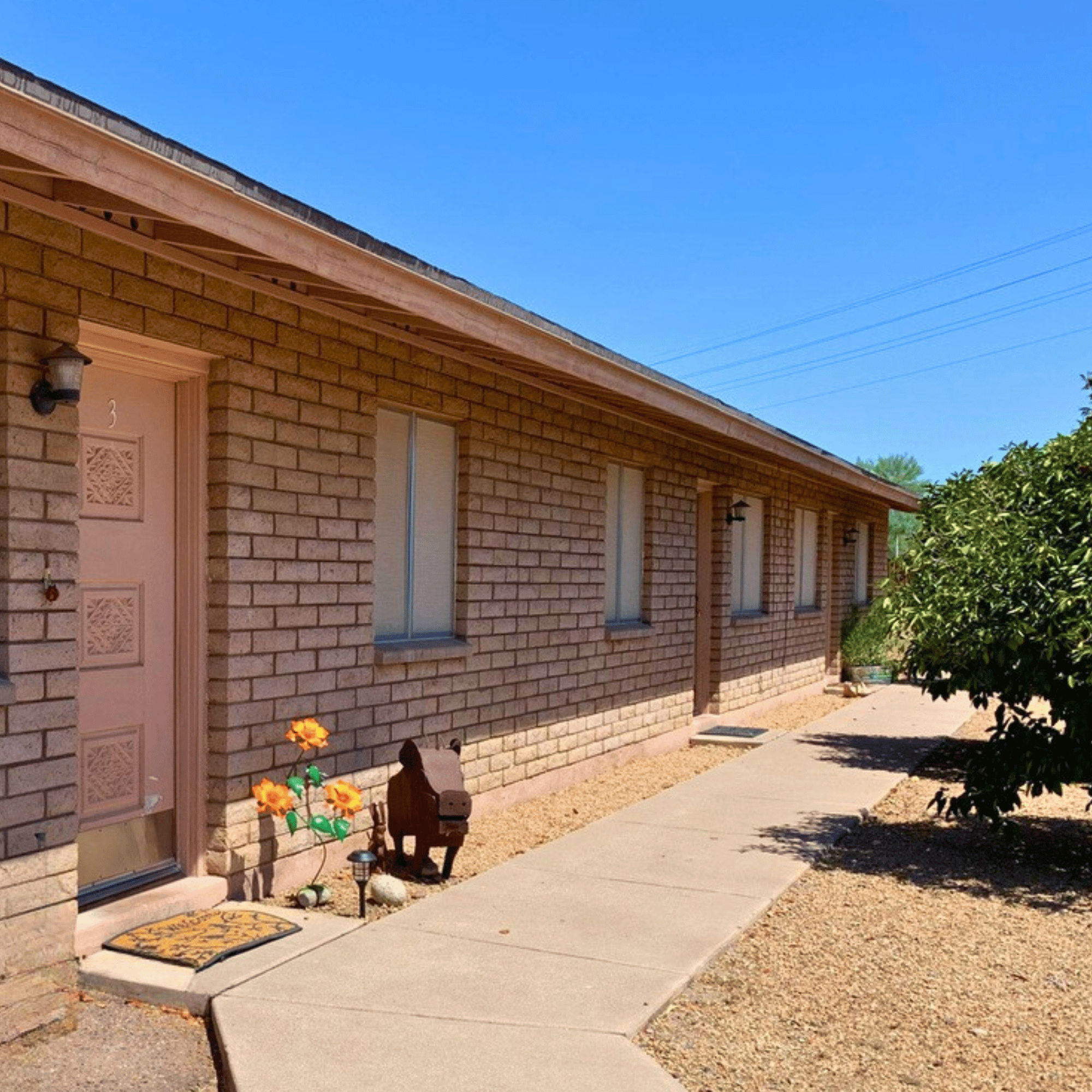 a brick building with a pink door